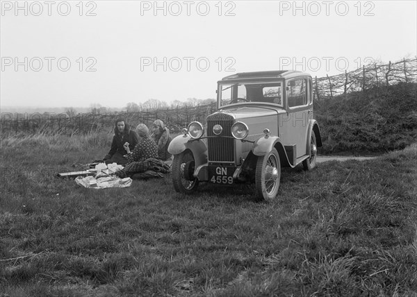 Three women having a picnic during a road test of a Triumph Scorpion, 1931. Artist: Bill Brunell.