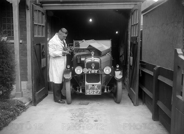 FA Thatcher working on his 1929 Triumph Super Seven. Artist: Bill Brunell.