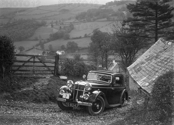 1934 Standard Avon Ten coupe taking part in a Standard Car Owners Club trial. Artist: Bill Brunell.