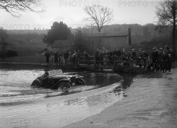 MG PA driving through a ford during a motoring trial, 1936. Artist: Bill Brunell.