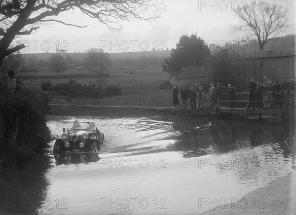 MG PA driving through a ford during a motoring trial, 1936. Artist: Bill Brunell.