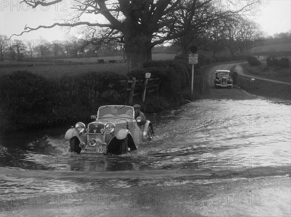 972 cc Singer Le Mans driving through a ford during a motoring trial, 1936. Artist: Bill Brunell.