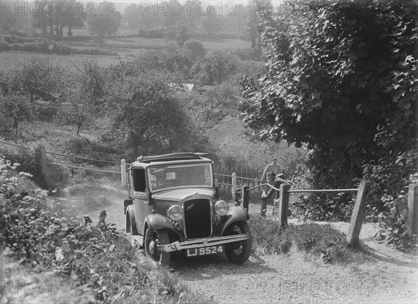 1934 Austin Ten taking part in a West Hants Light Car Club Trial, Ibberton Hill, Dorset, 1930s. Artist: Bill Brunell.