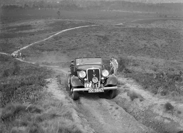 1934 Ford V8 open 2-seater taking part in the NWLMC Lawrence Cup Trial, 1937. Artist: Bill Brunell.