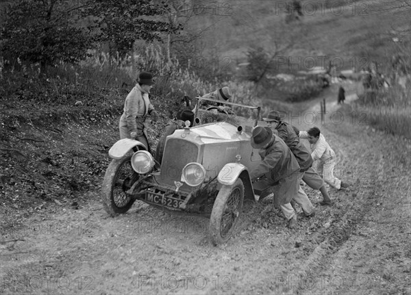 EA Beale's Vauxhall 30-98 Velox 4 seater receiving a push during the Inter-Varsity Trial, 1930. Artist: Bill Brunell.