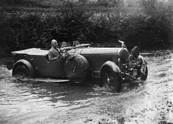 3-litre Lagonda of RD Tong fording the River Exe at Yealscombe, Devon, JCC Lynton Trial, 1932. Artist: Bill Brunell.