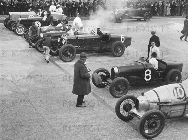 Cars on the start line at a BARC meeting, Brooklands, 1930. Artist: Bill Brunell.