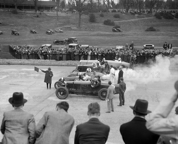 Cars on the start line at a BARC race meeting, Brooklands, 1930. Artist: Bill Brunell.