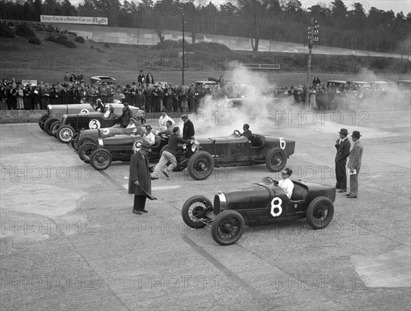 Cars on the start line at a BARC meeting, Brooklands, 1930. Artist: Bill Brunell.