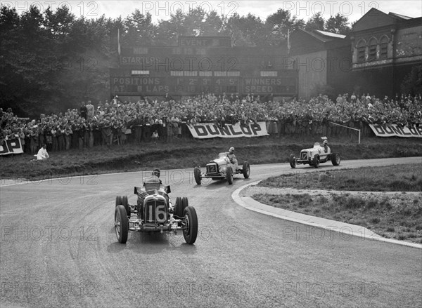 Raymond Mays' ERA leading an MG and another ERA, Imperial Trophy, Crystal Palace, 1939. Artist: Bill Brunell.