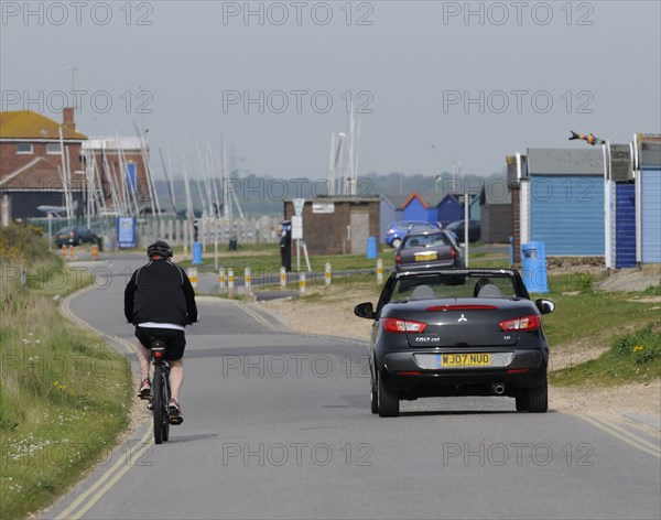 Mitsubishi Colt CZC cabriolet overtaking cyclist