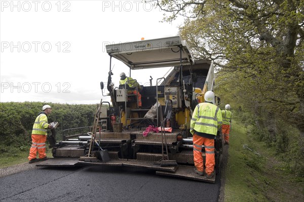 Road resurfacing work repairing potholes Artist: Unknown.