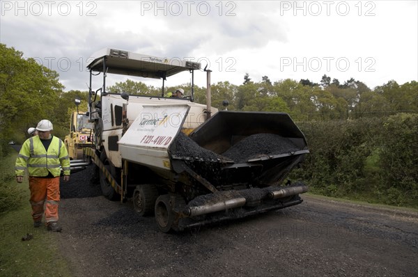 Road resurfacing work repairing potholes Artist: Unknown.