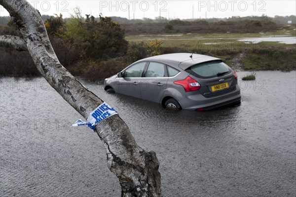 Ford Focus in flooded ditch after losing control on wet road 2012 Artist: Unknown.