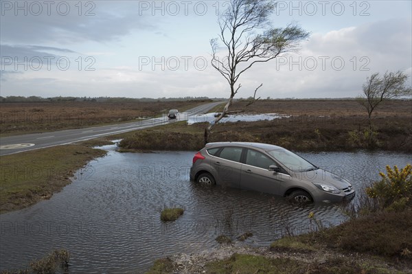 Ford Focus in flooded ditch after losing control on wet road 2012 Artist: Unknown.