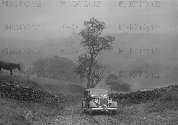 Ford V8 saloon of AKB Clarkson competing in the MCC Sporting Trial, 1935. Artist: Bill Brunell.