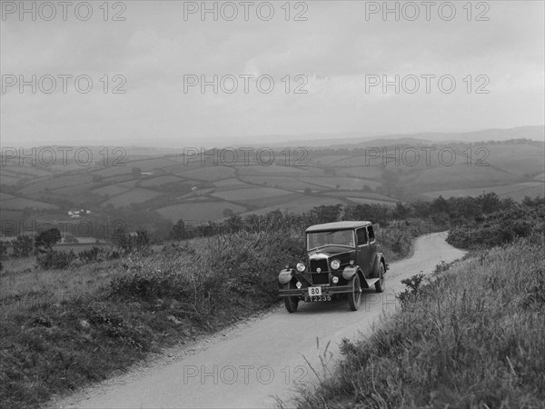 Riley Monaco saloon of VJ Fishleigh competing in the MCC Torquay Rally, 1938. Artist: Bill Brunell.