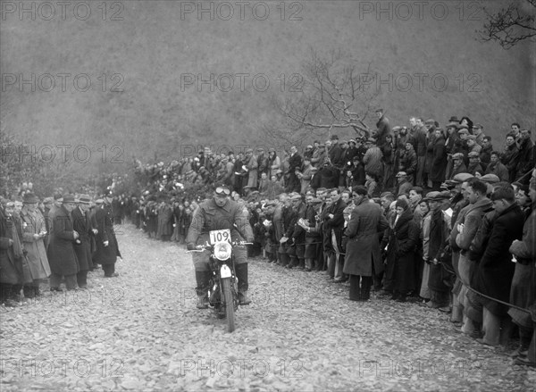 347 cc AJS of RW Cassam competing in the MCC Lands End Trial, Beggars Roost, Devon, 1936. Artist: Bill Brunell.