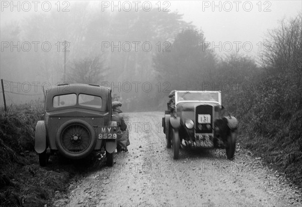 Triumph of J Cramer-Parry passing an official's Riley, MCC Exeter Trial, Blackhill, Dorset, 1930. Artist: Bill Brunell.