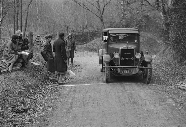 Kittu Brunell watching a Donnet competing in the Sunbeam Motor Car Club Bognor Trial, 1929. Artist: Bill Brunell.