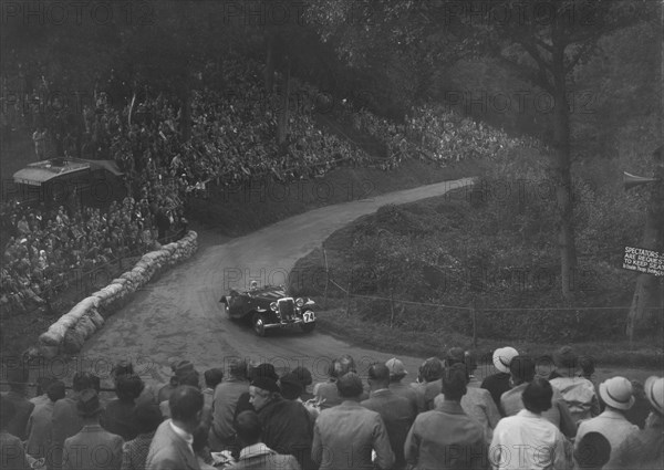 Unidentified open 4-seater car competing in the Shelsley Walsh Hillclimb, Worcestershire, 1935. Artist: Bill Brunell.