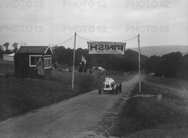 Unidentified offset single-seater car finishing the Shelsley Walsh Hillclimb, Worcestershire, 1935. Artist: Bill Brunell.