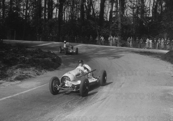 Riley of Hector Dobbs leading the MG Q type of Kenneth Evans, Donington Park, Leicestershire, 1935. Artist: Bill Brunell.