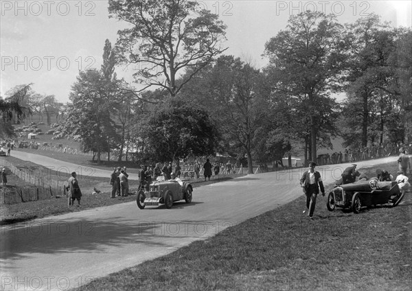 MG J2 passing the crashed Austin 7 of B Sparrow, Donington Park Race Meeting, Leicestershire, 1933. Artist: Bill Brunell.