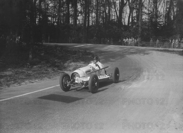 Riley offset-bodied single seater of Hector Dobbs racing at Donington Park, Leicestershire, 1935. Artist: Bill Brunell.