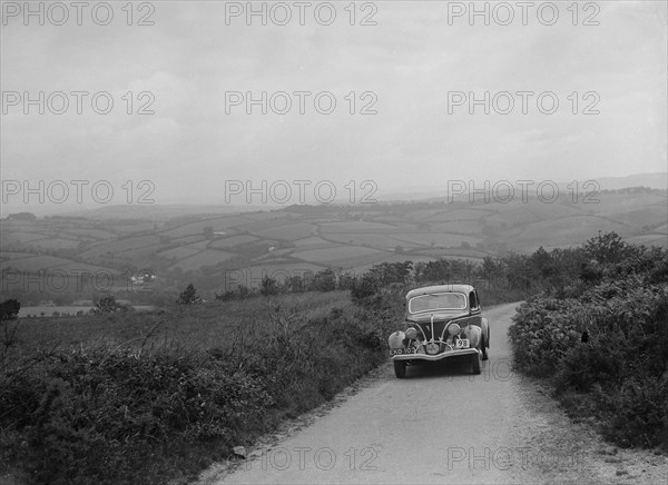 Ford V8 competing in the MCC Torquay Rally, 1938. Artist: Bill Brunell.