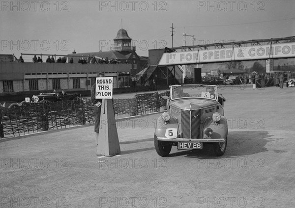 Ford Prefect tourer competing in the JCC Rally, Brooklands, Surrey, 1939. Artist: Bill Brunell.