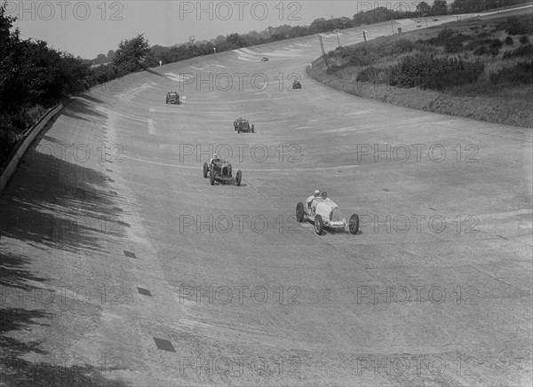 Bugatti T37s of Eileen Ellison and S Smith on Byfleet Banking, BARC meeting, Brooklands, 1933. Artist: Bill Brunell.