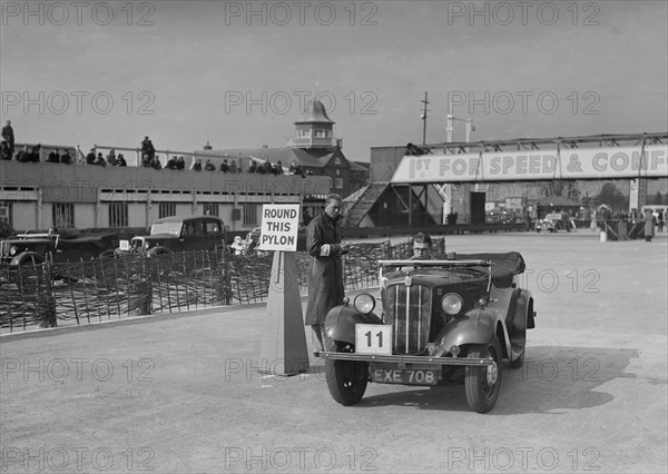 Morris 8 tourer competing in the JCC Rally, Brooklands, Surrey, 1939. Artist: Bill Brunell.
