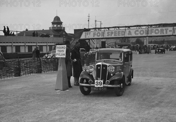 Standard Nine saloon competing in the JCC Rally, Brooklands, Surrey, 1939. Artist: Bill Brunell.