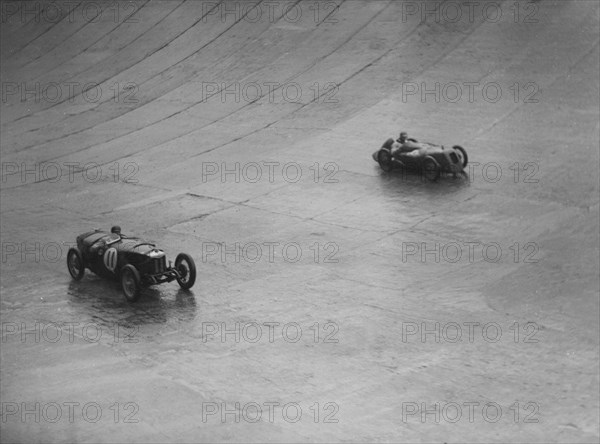 Riley 9 Brooklands and Austin 7 racing at a BARC meeting, Brooklands, Surrey, 1931 Artist: Bill Brunell.