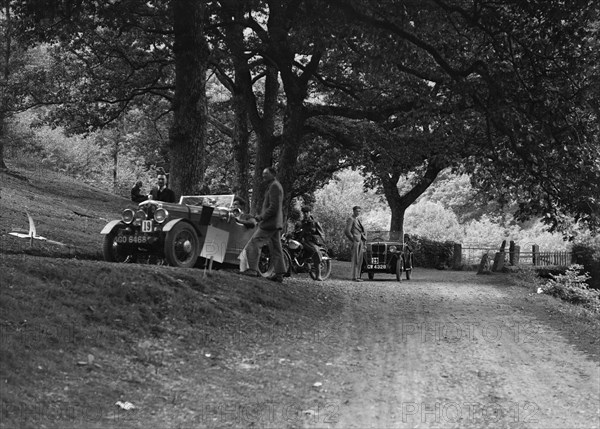 Wolseley Hornet and Morris Minor taking part in a motoring trial, c1930s. Artist: Bill Brunell.