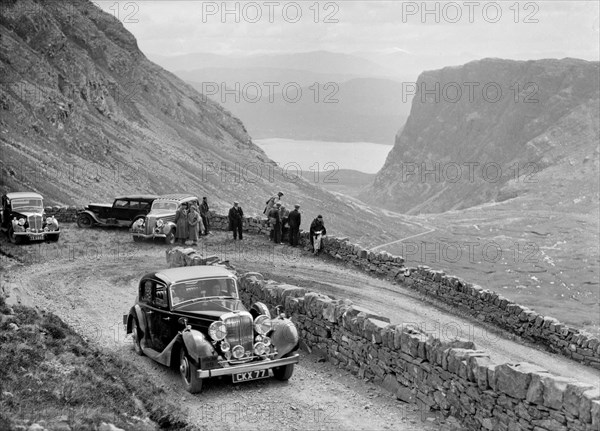 SS Jaguar saloon of DS Hand competing in the RSAC Scottish Rally, 1936. Artist: Bill Brunell.