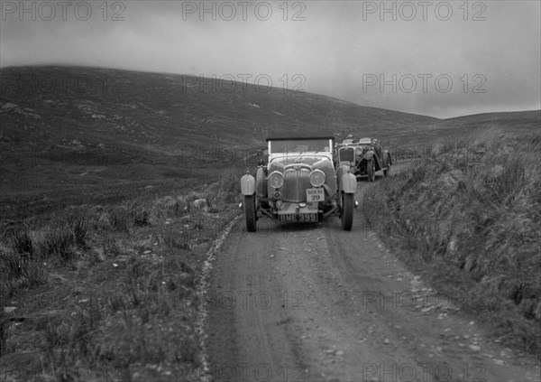 Aston Martin of Mrs JW Rutherford competing in the RSAC Scottish Rally, 1934. Artist: Bill Brunell.