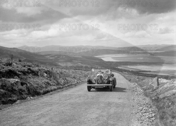 Lagonda open tourer of CG Seddon competing in the RSAC Scottish Rally, 1934. Artist: Bill Brunell.