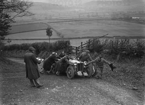 MG PB of K Scales getting a push during the MG Car Club Midland Centre Trial, 1938. Artist: Bill Brunell.