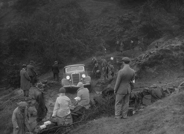 Ford V8 drop head coupe of GM Denton competing in the MCC Sporting Trial, 1935. Artist: Bill Brunell.