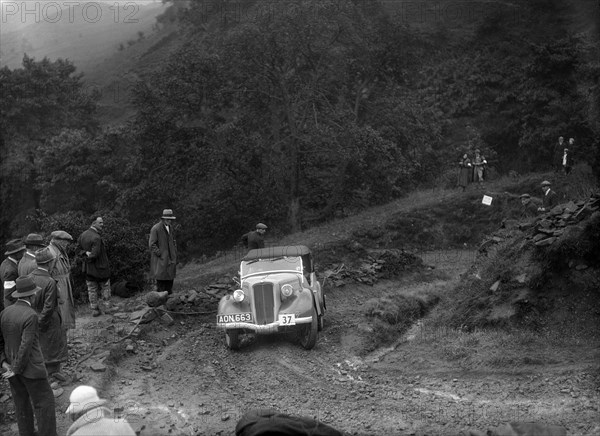 Ford 10 tourer of J Harrison competing in the MCC Sporting Trial, 1935. Artist: Bill Brunell.