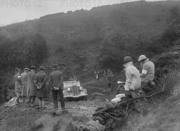 Ford 10 tourer of J McEvoy competing in the MCC Sporting Trial, 1935. Artist: Bill Brunell.