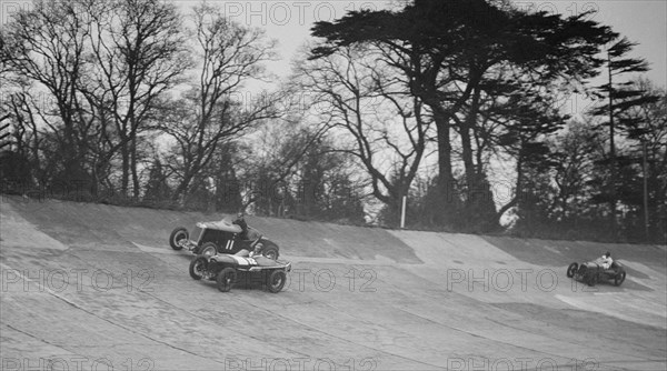 Lea-Francis Hyper of AS Llewellyn and Amilcar of Major A Gardner, BARC meeting, Brooklands, 1930. Artist: Bill Brunell.