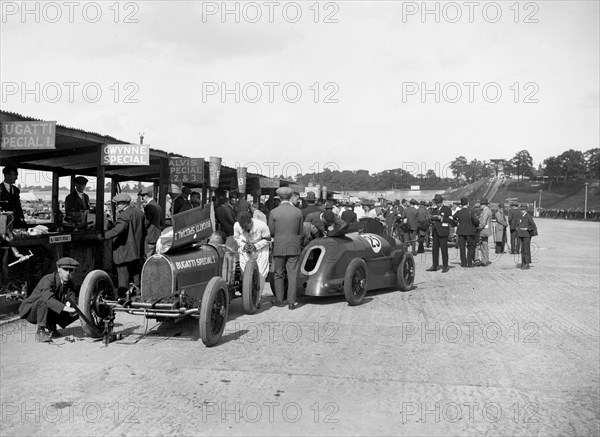 Bugatti Special 1 and Gwynne Special in the pits at a BARC meeting, Brooklands, 1933. Artist: Bill Brunell.