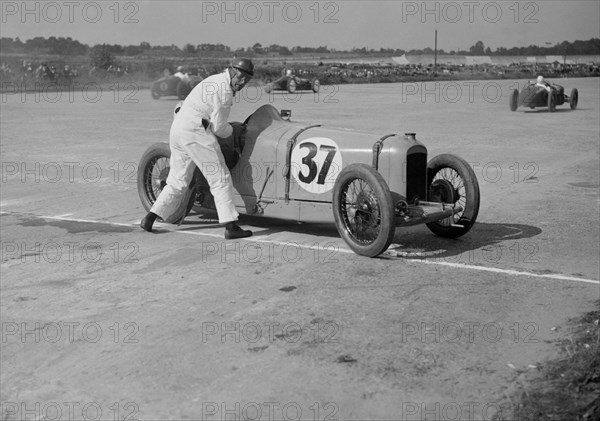 Charles Martin restarting his Amilcar after skidding, JCC 200 Mile Race, Brooklands, 1926. Artist: Bill Brunell.