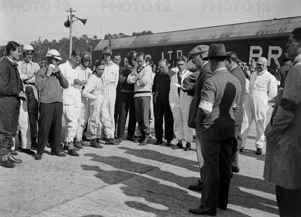 Drivers being addressed at the JCC 200 Mile Race, Brooklands, 1926. Artist: Bill Brunell.