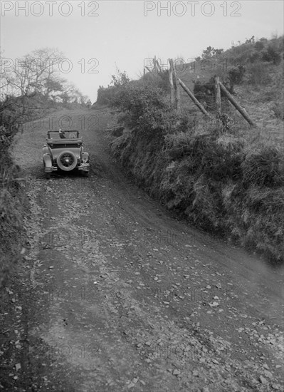 Kitty Brunell driving a 1930 2-seater Ford Model A, 1931.   Artist: Bill Brunell.