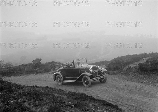 Kitty Brunell driving a 1930 2-seater Ford Model A, 1931.   Artist: Bill Brunell.