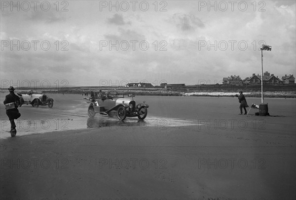 Bentley of ER Insole and Austin of RW Thomas competing in the Porthcawl Speed Trials, Wales, 1922. Artist: Bill Brunell.